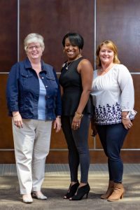 Angel Moore, center, Director of Practice Support at Eastern AHEC, pictured with two of her team members.