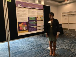 Angel Moore, Director of Eastern AHEC Practice Support, standing with her first-place poster at the International Conference on Practice Facilitation in December 2018.